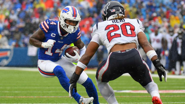 Oct 3, 2021; Orchard Park, New York, USA; Buffalo Bills wide receiver Stefon Diggs (14) runs with the ball as Houston Texans strong safety Justin Reid (20) defends during the second half at Highmark Stadium.